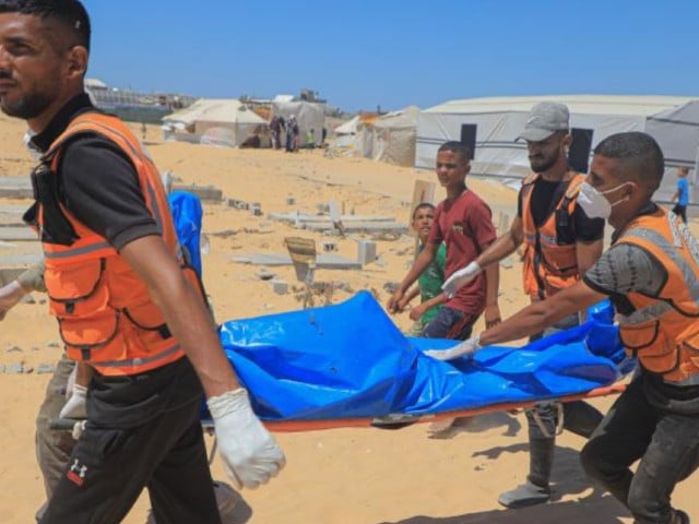 workers carry bodies of unidentified palestinians killed by the israeli army in the southern gaza strip city of khan younis on aug 5 2024 israel had returned the bodies of 89 palestinians killed by the israeli army in the gaza strip the hamas run gaza government media office said on monday photo xinhua